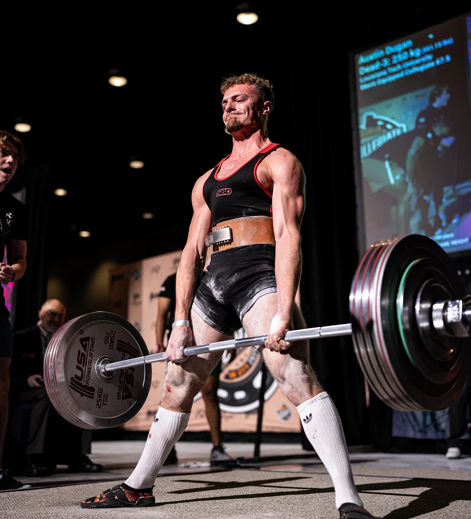 A man deadlifting a bar